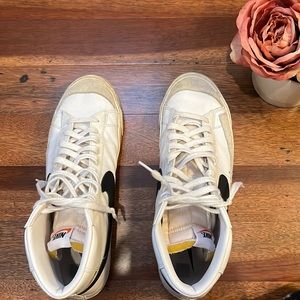 Nike men’s Blazer ‘77 leather high-top sneakers. White with black swoosh.